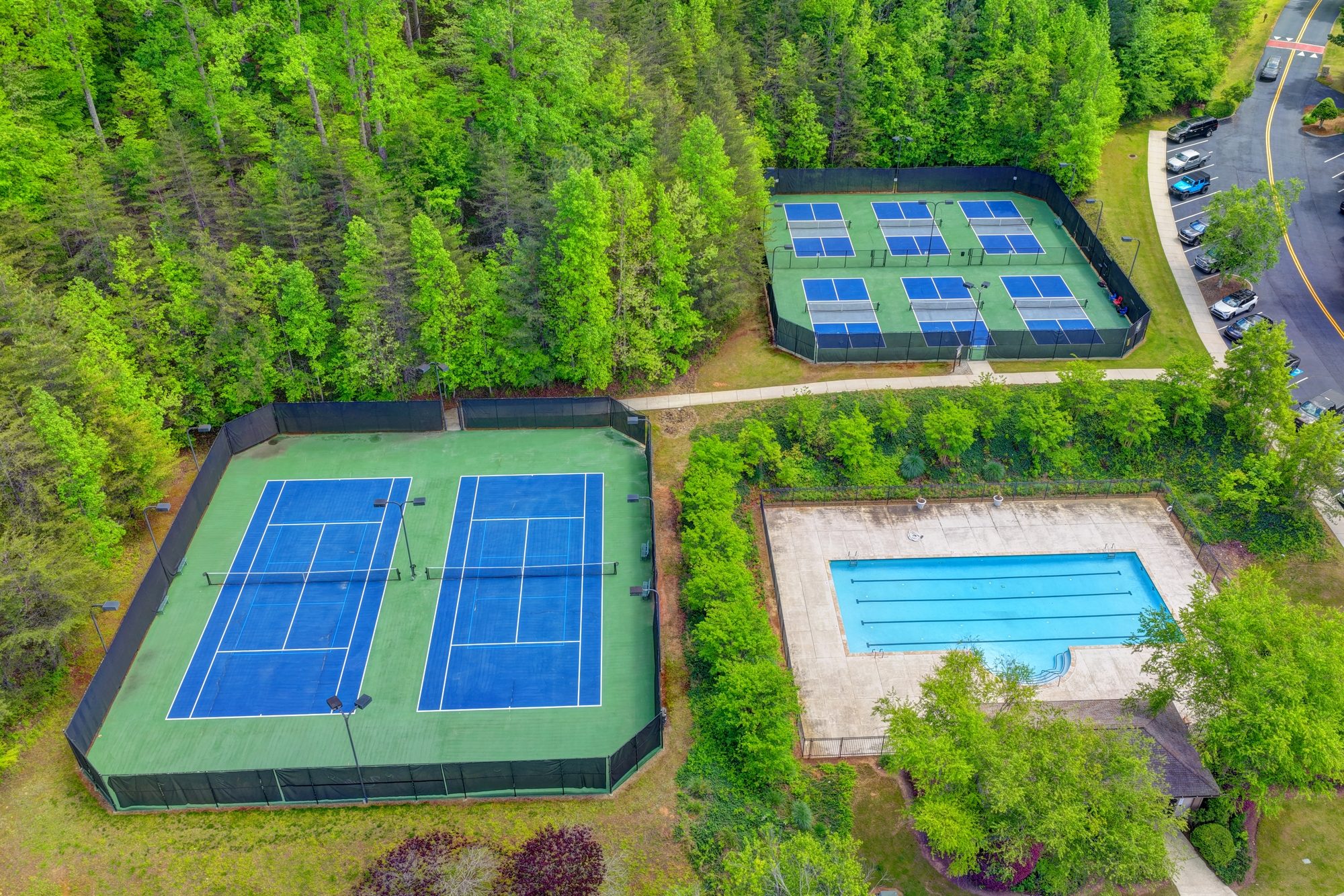 Tennis and pickleball courts surrounded by pines