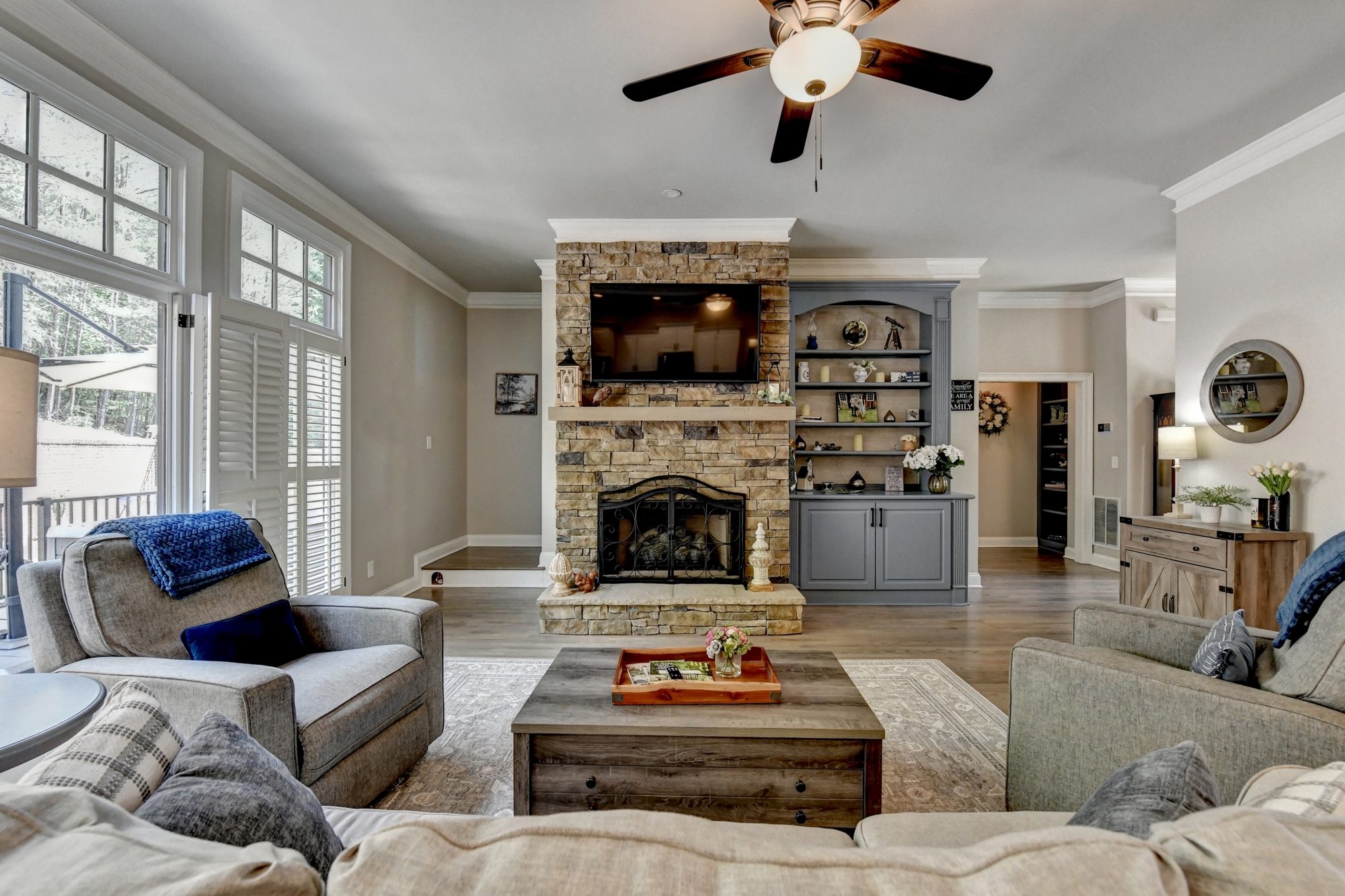 Great room interior with vaulted ceilings and stone fireplace